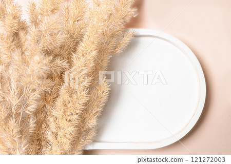 White empty cement platform podium and dry reed grass 121272003