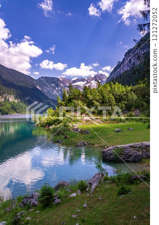 Beautiful nature on the shores of the Vorderer Gosausee lake near Gosau, Austria, sunny summer day Beautiful nature on the shores of the Vorderer Gosausee lake near Gosau, Austria, sunny summer day 121272052