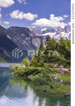 Beautiful nature on the shores of the Vorderer Gosausee lake near Gosau, Austria, sunny summer day Beautiful nature on the shores of the Vorderer Gosausee lake near Gosau, Austria, sunny summer day 121272053