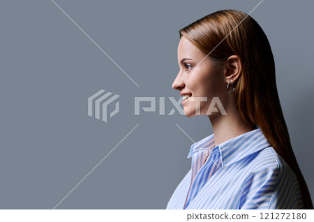 Profile portrait of young teenage girl, gray studio copy space background 121272180