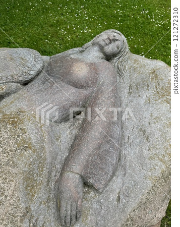 Stone Sculpture of Reclining Woman on Grass Background Stone Sculpture of Reclining Woman on Grass Background 121272310