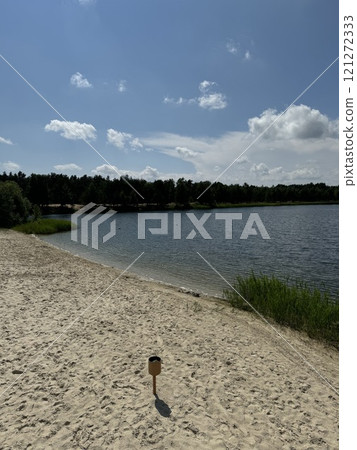 Sunny Lakeshore with Sand and Blue Sky View 121272333