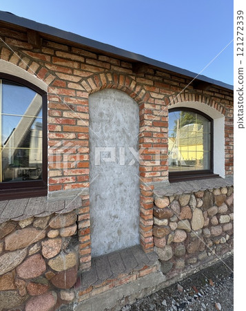 Rustic Brick and Stone Wall with Arched Windows Rustic Brick and Stone Wall with Arched Windows 121272339