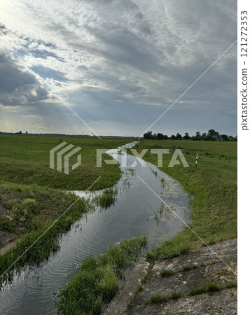 Meandering Stream Through Peaceful Green Fields 121272353