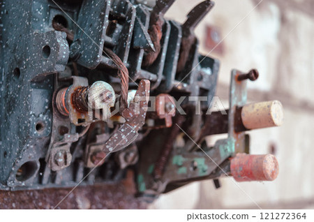 an old broken switch mechanism in which the insides with small wires, bolts and other electrically conductive filling. Old plastic copper and silver contacts. depressing post-apocalyptic View of a 121272364
