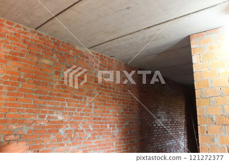 brick wall in the room. Wall joints in an unfinished building room brick wall in the room. Wall joints in an unfinished building room 121272377