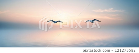 Seagulls flying over calm waters at sunrise with pastel colors in the sky Seagulls flying over calm waters at sunrise with pastel colors in the sky 121273582