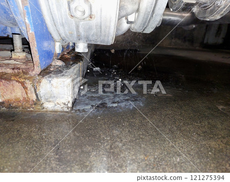 Cobwebs and Fluid Leakage Observed Under a Stainless Steel Centrifugal Pump in an Industrial Setting 121275394