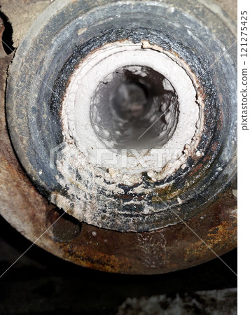 Pipe With Limestone Deposits Inside Showing Buildup in an Industrial Setting 121275425