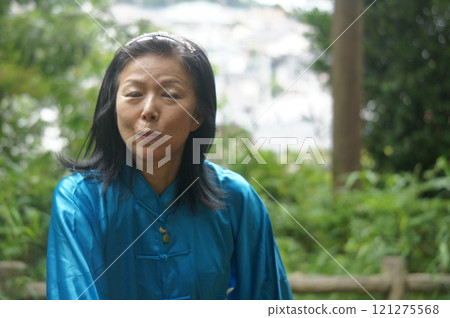 Tall woman stretching in the forest 121275568