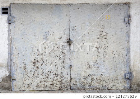 old metal door to the car garage old metal door to the car garage 121275629