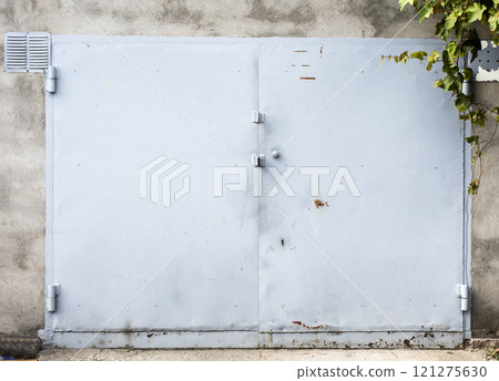old metal door to the car garage old metal door to the car garage 121275630