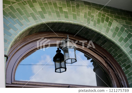 green street lamp on background of semicircular window green street lamp on background of semicircular window 121275789