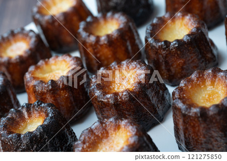 Canneles de bordeaux, traditional French sweet dessert with white table background Canneles de bordeaux, traditional French sweet dessert with white table background 121275850