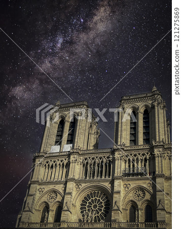 Notre dame cathedral, Paris on a cloudy evening under a starry sky 121275869