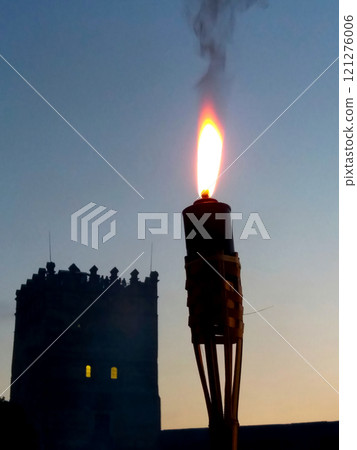 Illuminated Torch by the Lutsk Castle Tower at Night, Showcasing Historical Architecture 121276006