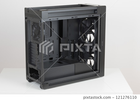 Side view of empty big tower, PC case, chasssis, without upper and tempered-glass left panel. At the bottom is a cover for power supply unit. Side view of empty big tower, PC case, chasssis, without upper and tempered-glass left panel. At the bottom is a cover for power supply unit. 121276110