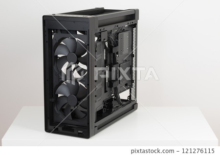 Side view of empty  big tower, PC case, chassis, without upper , front, right  metal panel  and  tempered-glass left  panel. Two  pre-installed system extra-thick 200 x 38 mm front fans. 121276115