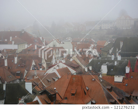 Cityscape of Cesky Krumlov historical center old town in a foggy gloomy smog winter weather Cityscape of Cesky Krumlov historical center old town in a foggy gloomy smog winter weather 121276232