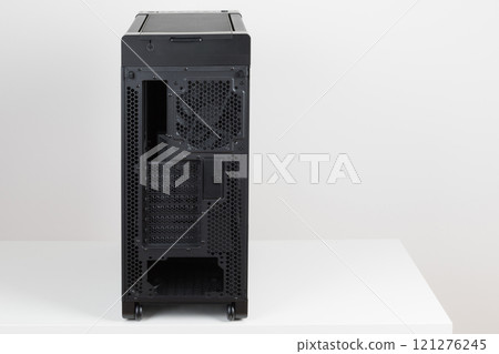 Back side of empty big tower computer case, chassis , effortless maneuvering with two built-in wheels on white background. At the bottom is a place for power supply unit Back side of empty big tower computer case, chassis , effortless maneuvering with two built-in wheels on white background. At the bottom is a place for power supply unit 121276245