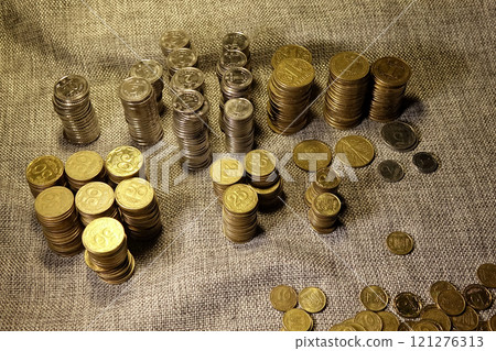 Detailed Study of Modern Ukrainian Coins Stacked in Neat Columns on Fabric Surface Detailed Study of Modern Ukrainian Coins Stacked in Neat Columns on Fabric Surface 121276313