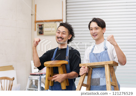 Men making DIY chairs (fist pump) Men making DIY chairs (fist pump) 121276529