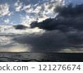 Storm clouds, rain and sun over the sea 121276674