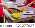 Chefs preparing traditional Chaulafan con marisco ecuadorian food in a restaurant kitchen 121277027
