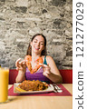 Woman making heart shape with shrimp at ecuadorian restaurant in madrid 121277029