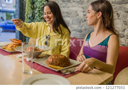 Women enjoying traditional ecuadorian food in a madrid restaurant Women enjoying traditional ecuadorian food in a madrid restaurant 121277031