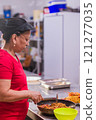 Latin american chef preparing traditional ecuadorian dish in restaurant kitchen 121277035