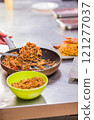 Chef preparing Chaulafan con marisco traditional ecuadorian dish in ecuadorian restaurant 121277037
