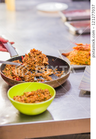 Chef preparing Chaulafan con marisco traditional ecuadorian dish in ecuadorian restaurant Chef preparing Chaulafan con marisco traditional ecuadorian dish in ecuadorian restaurant 121277037