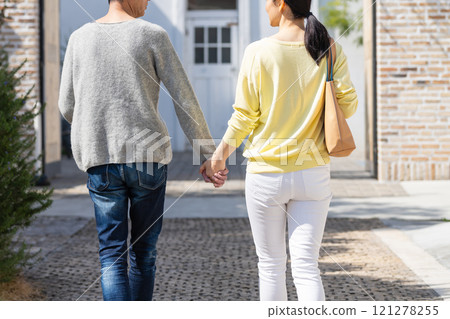 Back view of a middle-aged couple walking hand in hand Back view of a middle-aged couple walking hand in hand 121278255