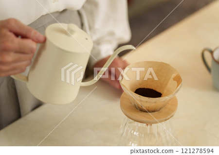 Middle-aged woman brewing coffee at night 121278594