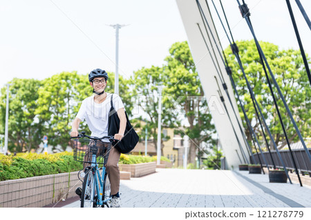 A young man riding a bicycle A young man riding a bicycle 121278779