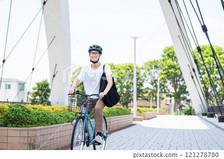 A young man riding a bicycle A young man riding a bicycle 121278780