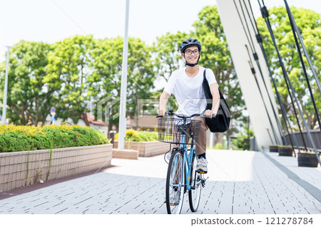A man riding a bicycle 121278784