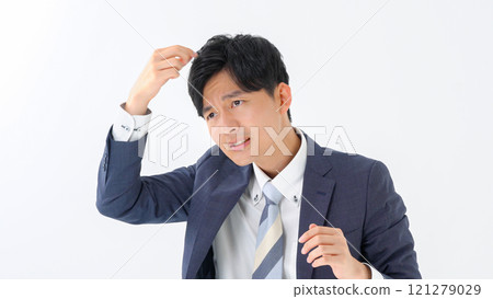 Businessman doing hair styling 121279029