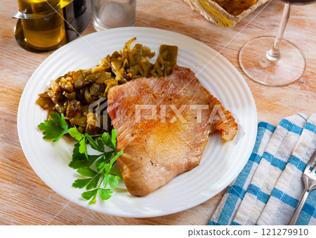 Fried Iberian pig with beans and parsley Fried Iberian pig with beans and parsley 121279910