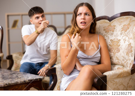 Family quarrel. Couple during conflict in live roome Family quarrel. Couple during conflict in live roome 121280275