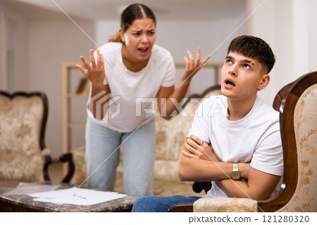 Angry young woman swears at her spouse Angry young woman swears at her spouse 121280320