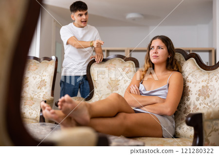 Disgruntled young husband swears at his wife 121280322