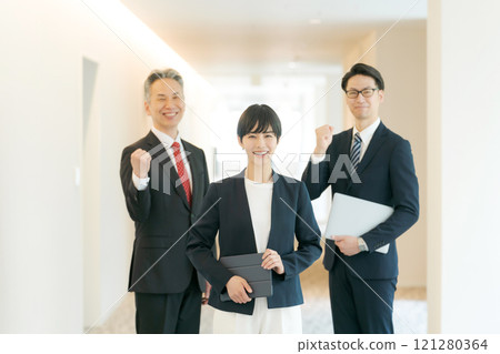 Men and women of a suit wearing a guts pose 121280364