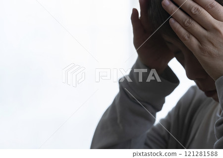 Senior woman covering her face with her hands 121281588