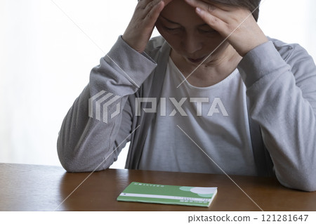 Senior woman covering her face with her hands 121281647