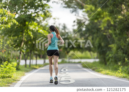 The start into the new year 2025. Start up of runner woman running on nature race track go to Goal of Success The start into the new year 2025. Start up of runner woman running on nature race track go to Goal of Success 121282175