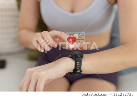 Women Point to smartwatch displaying heart rate application. Monitoring virtual display measure heart rate before after physical exercise. wristwatch checking heart beats and pulse. 121282723