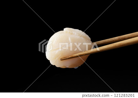 Scallop sashimi picked up with chopsticks 121283201