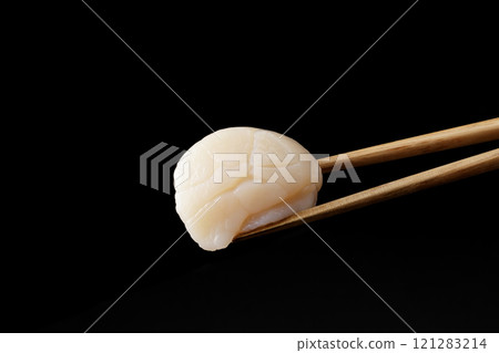 Scallop sashimi picked up with chopsticks 121283214